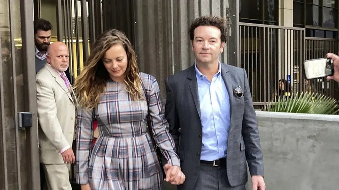 Actor Danny Masterson leaving court with his wife Bijou Phillips last year, after a judge declared a mistrial. Masterson's retrial has begun. Photo / AP
