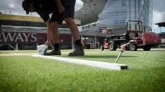 Eden Park turf assistant Niko Weerakoon repaints the pitch on the outer oval. Photo / Carson Bluck