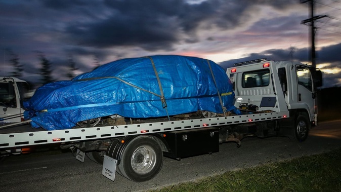 A tow truck is shown removing the burnt-out vehicle from Irongate Rd on Wednesday. Photo / Paul Taylor