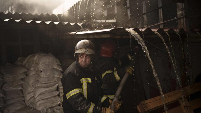 Firefighters battle a fire following a Russian attack in Kharkiv, Ukraine, March 25, 2022. Photo / AP