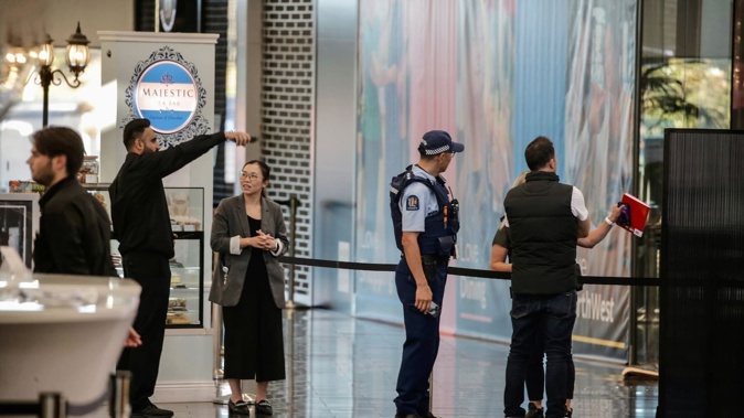 Police at Westgate's Northwest Shopping Centre in Massey after armed robbers raided the Michael Hill Jeweller store. Photo / Alex Burton