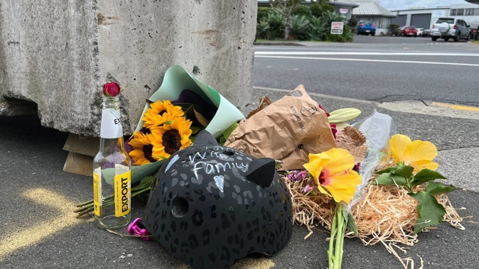A cyclist and others who knew the victim paid respects at the crash site this morning. Photo / NZME