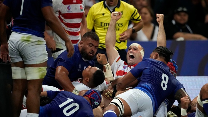 Japan's Craig Millar celebrates after his captain Kazuki Himeno scored a try during the Rugby World Cup Pool D match between Japan and Samoa. Photo / AP
