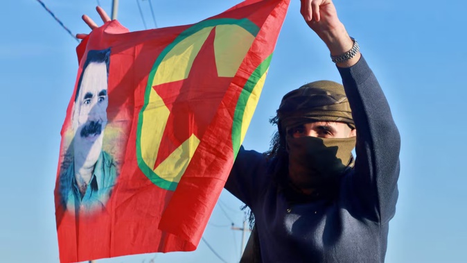 An Iraqi Kurdish woman waves a flag bearing the portrait of the founder of the Kurdistan Worker's Party (PKK) Abdullah Ocalan as people gather at Freedom Park to listen to an audio message by the jailed leader in Sulaimaniyah, in Iraq's autonomous Kurdistan region on February 27, 2025. Photo / Shwan Mohammed / AFP