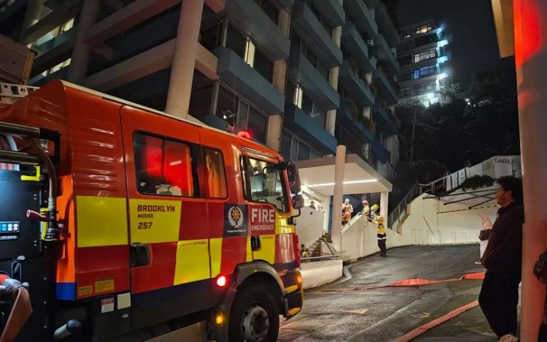 Fire and Emergency NZ at the scene of a fire in Church St, Wellington, tonight. Photo / Nick James, RNZ