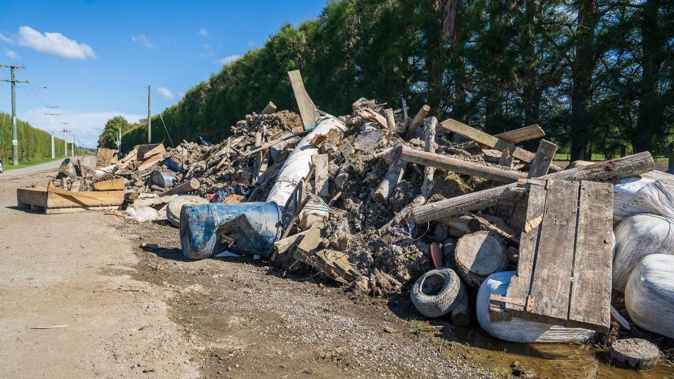 Silt and waste on a roadside in cyclone-affected Pākōwhai.
