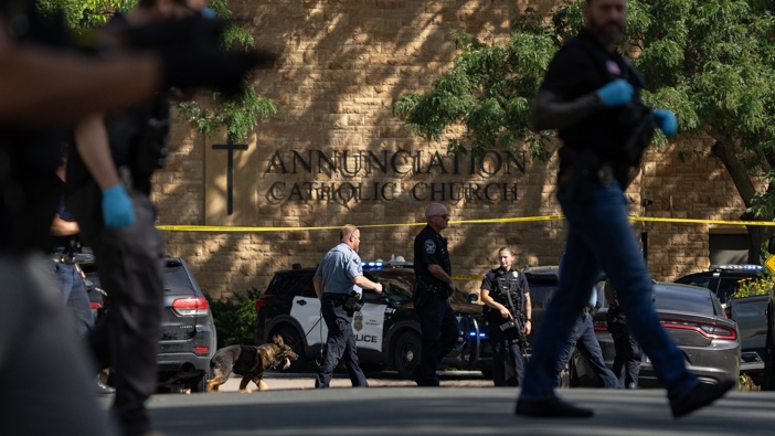 Law enforcement officers search the nearby neighborhood to clear the area after a shooting at Annunciation Church in Minneapolis, Minn. on Wednesday, August 27, 2025. (Photo by Alex Kormann/The Minnesota Star Tribune via Getty Images)
