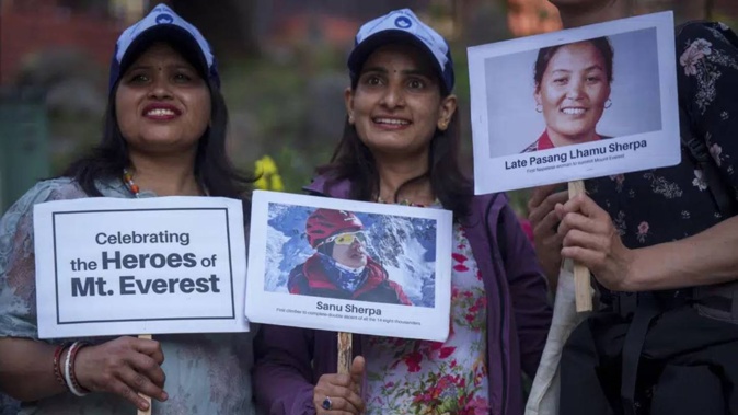 Women hold placards and photos of various record-holding climbers as they mark the 70 anniversary of the first ascent of Mount Everest in Kathmandu. Photo / AP