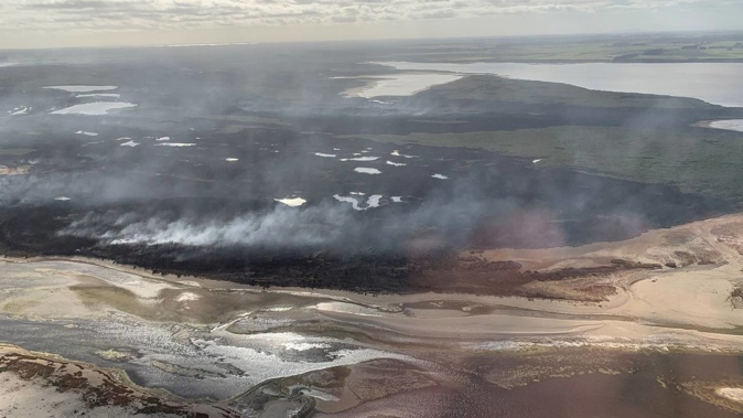 A large fire is burning in an "extremely significant" wetland in Southland with Ngāi Tahu fearing some of the species that call it home may die. Photo / Dean Whaanga Te Rūnaka o Awarua Kaiwhakahaere