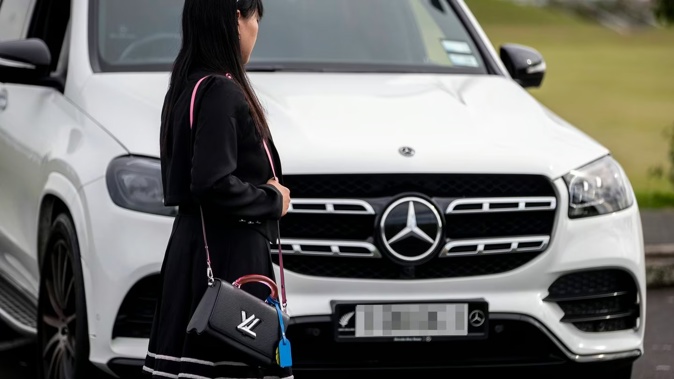 Feng with her Mercedes-Benz, which she says has been plagued with mechanical issues including a faulty seatbelt. Photo / Michael Craig
