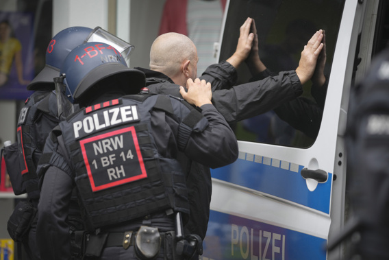 Police officers search England soccer fan ahead the Group C match between Serbia and England at the Euro 2024 soccer tournament in Gelsenkirchen, Germany, Sunday, June 16, 2024. (AP Photo/Markus Schreiber)