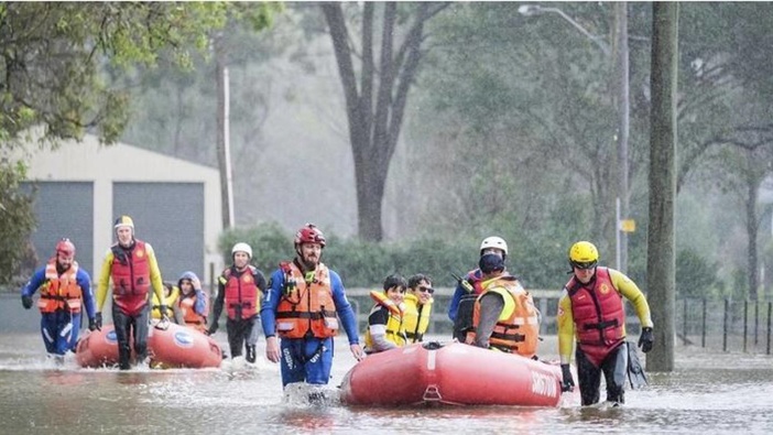 NSW lifesavers embedded with the NSW SES assist with a flood rescue in Penrith. (Photo / NSW SES)