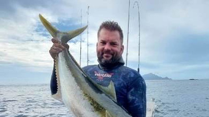 Steven King with the kingfish he was unwilling to share with a shark.