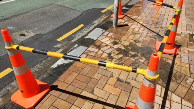 A water leak bubbling up through the paving stones behind the Old Bank Arcade in Wellington's city centre in January 2024. Representatives from councils in the Wellington region will meet this week to discuss working together on a water plan. Photo: RNZ / Jemima Huston