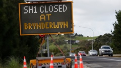 Signs like this one at State Highway 1 in Oakleigh, near the Paparoa turn-off intersection, are set to remain up until the Brynderwyns reopen in June. Photo / Michael Cunningham.
