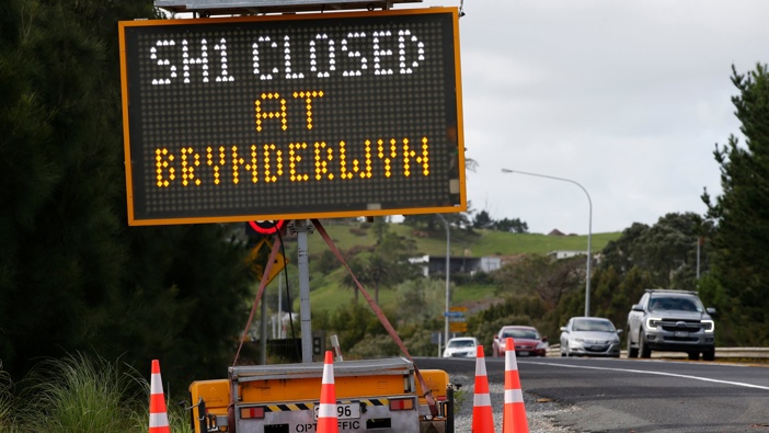 Signs like this one at State Highway 1 in Oakleigh, near the Paparoa turn-off intersection, are set to remain up until the Brynderwyns reopen in June. Photo / Michael Cunningham.