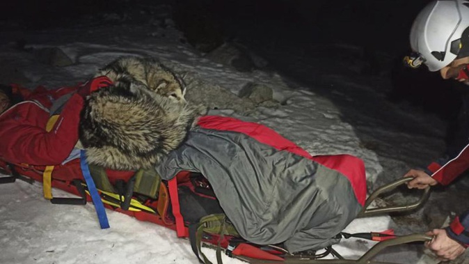 This photo provided by Croatian Mountain Rescue Service shows a hiker and his dog during a rescue operation at Mount Velebit, in Croatia. (Photo / AP)
