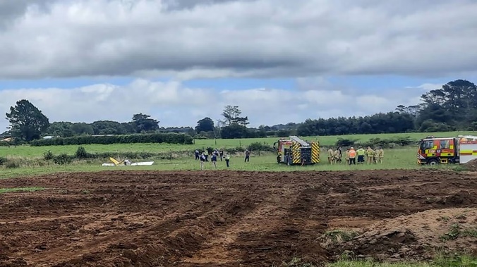 Emergency services at the scene of a light aircraft crash near Stratford. Photo / Ilone Hanne