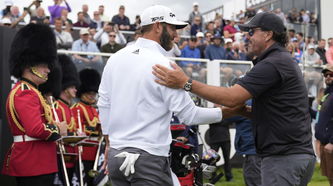 Dustin Johnson of the United States, left, and Phil Mickelson of the United States greet each other on the first tee during the first round of the inaugural LIV Golf Invitational at the Centurion Club in St. Albans, England. Photo / AP