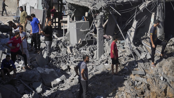Palestinians look at buildings destroyed in the Israeli bombardment in the morgue in Deir al Balah, Gaza Strip, Tuesday, Nov. 7, 2023. Photo / AP