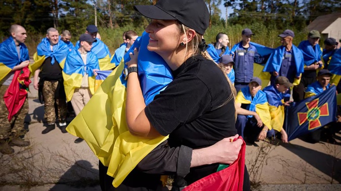 A volunteer hugs a Ukrainian prisoner of war following a swap at an undisclosed location in Ukraine. Russia said it swapped 103 Ukrainian soldiers held captive for an equal number of Russian POWs in an exchange deal brokered by the United Arab Emirates. Photo / AFP / Ukrainian Presidential Press Service