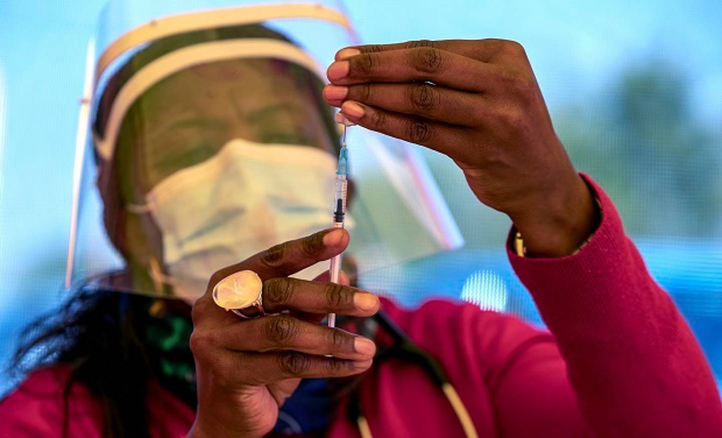 A health worker prepares a dose of the Pfizer coronavirus vaccine at the newly opened mass vaccination programme for the elderly at a drive-through vaccination centre outside Johannesburg. Photo / AP