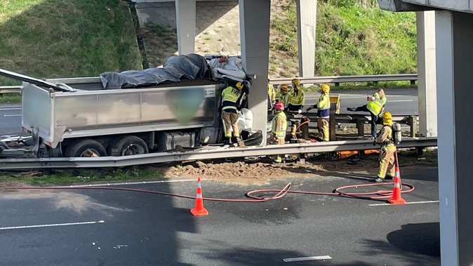 Rescue services work to free a truck driver after a crash on Auckland's Southern Motorway near Drury. Photo / Getty Images
