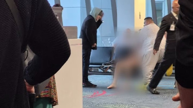 The man was restrained by a passenger on another flight, who held him down on a chair near the gate before police arrived within five minutes.