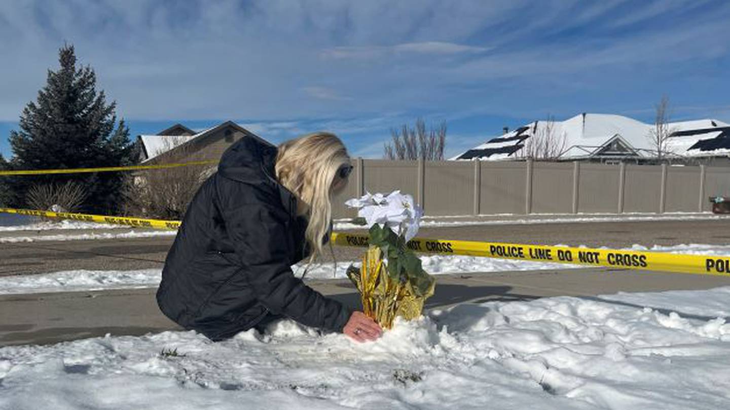 Sharon Huntsman, a member of The Church of Jesus Christ of Latter-day Saints from Cedar City, Utah, leaves flowers outside a home where eight family members were found dead in Enoch, Utah this week in a murder-suicide. Photo / AP