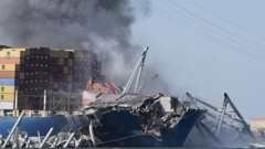 Explosive charges are detonated to bring down sections of the collapsed Francis Scott Key Bridge resting on the container ship Dali. Photo / AP
