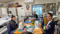 Front L-R: Florence Patel-Gaunt, 13, and Claudia Patel-Gaunt, 14, joined by Marg Wallace to sew together pencil cases and book bags for the Project Pencil Case. Photo / Supplied