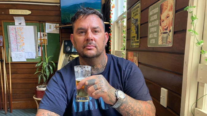 501 deportee Aaron Paul Pryce raises a glass after having a condition not to enter licensed premises deleted in the Whanganui District Court on Tuesday.