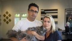 Anna and Bevan Russell with their cat Yoda. The family returned from holiday to discover another of their cats, Minka, was lost by the cattery. Photo / Michael Craig