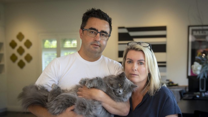 Anna and Bevan Russell with their cat Yoda. The family returned from holiday to discover another of their cats, Minka, was lost by the cattery. Photo / Michael Craig
