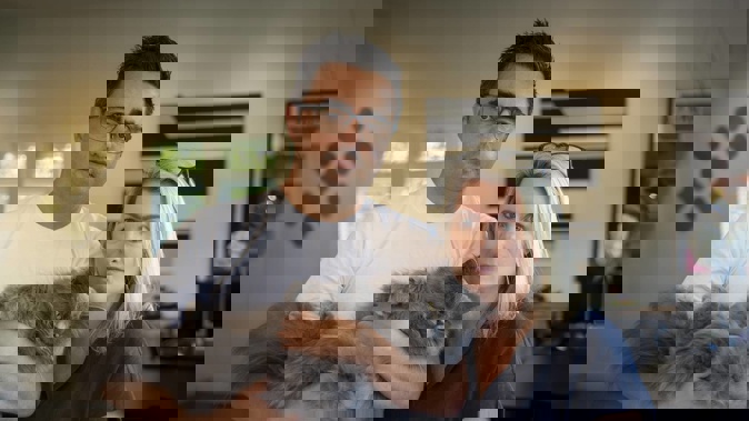 Anna and Bevan Russell with their cat Yoda. The family returned from holiday to discover another of their cats, Minka, was lost by the cattery. Photo / Michael Craig