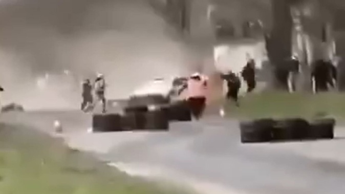 Videos on social media showed a car losing traction on a paved road before sliding into spectators. Photo / X