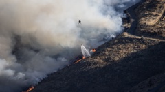 Firefighters battling a fire on Christchurch's Port Hills. Photo / George Heard