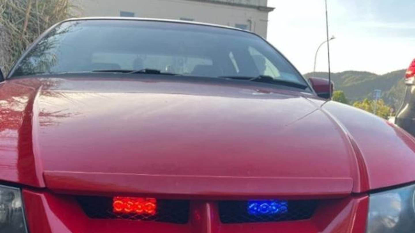 Driver arrested after joining police convoy in Commodore with flashing blue and red lights