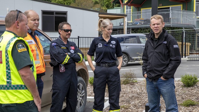 Prime Minister Chris Hipkins with search and rescue team members in the Esk Valley, north of Napier on February 17. Photo / Mark Mitchell