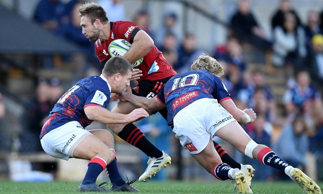 Braydon Ennor of the Crusaders is tackled by James Tuttle and Carter Gordon of the Rebels. (Photo / Photosport)