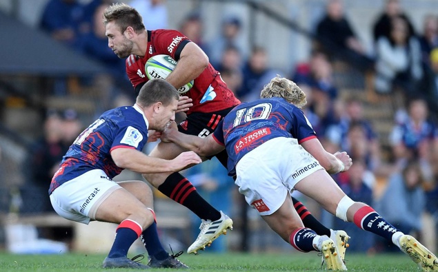 Braydon Ennor of the Crusaders is tackled by James Tuttle and Carter Gordon of the Rebels. (Photo / Photosport)