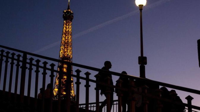 Lights on the Eiffel Tower will soon be turned off an hour earlier at night as part of an energy savings plan. Photo / AP
