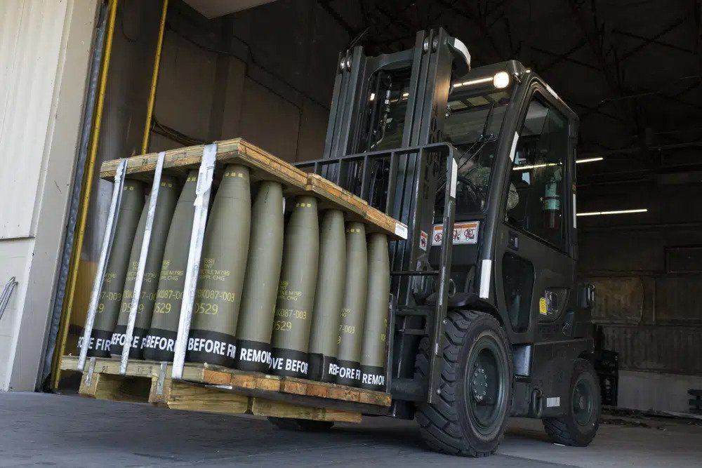 Airmen with the 436th Aerial Port Squadron use a forklift to move 155 mm shells ultimately bound for Ukraine, April 29, 2022, at Dover Air Force Base, Del. Officials say the U.S. will send Ukraine about $500 million in ammunition and equipment and will spend more than $2 billion to buy an array of munitions, radar and other weapons in the future. (AP Photo/Alex Brandon)