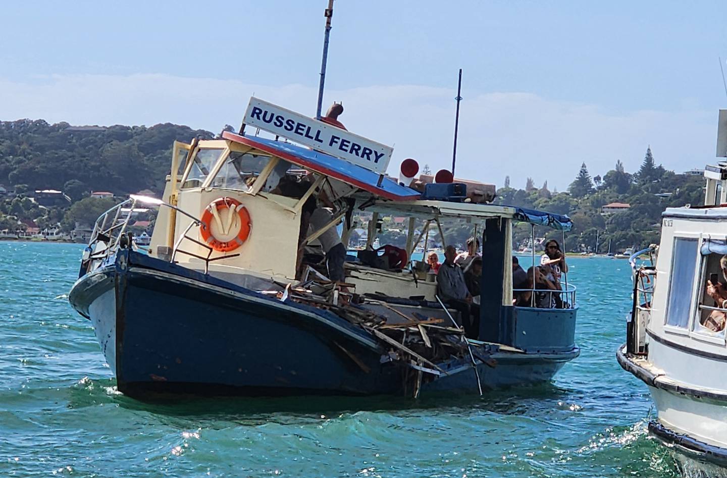 Passengers on the stricken Waitere Ferry also known as the 'Blue Ferry' wait to be rescued by the Happy Ferry. Photo / Supplied