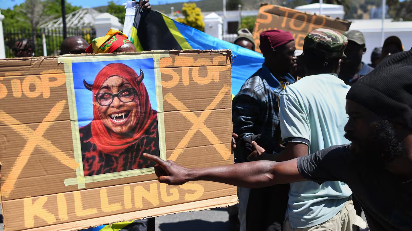 Protesters hold a placard with a picture of the augmented face of Tanzanian President Samia Suluhu Hassan, during a picket where about 50 Tanzanians living in Cape Town protested against the recent actions by the Tanzanian Government during that country's presidential election. Photo / Rodger Bosch, AFP