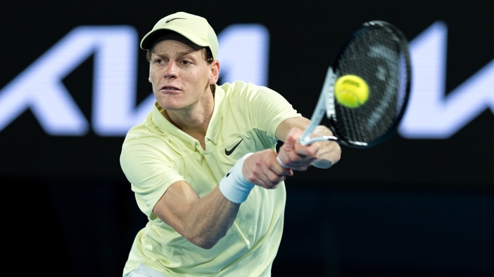 Jannik Sinner of Italy plays a backhand against Ben Shelton of the United States in the Men's Singles Semifinal during day 13 of the 2025 Australian Open at Melbourne Park on January 24, 2025 in Melbourne, Australia. (Photo by Andy Cheung/Getty Images)