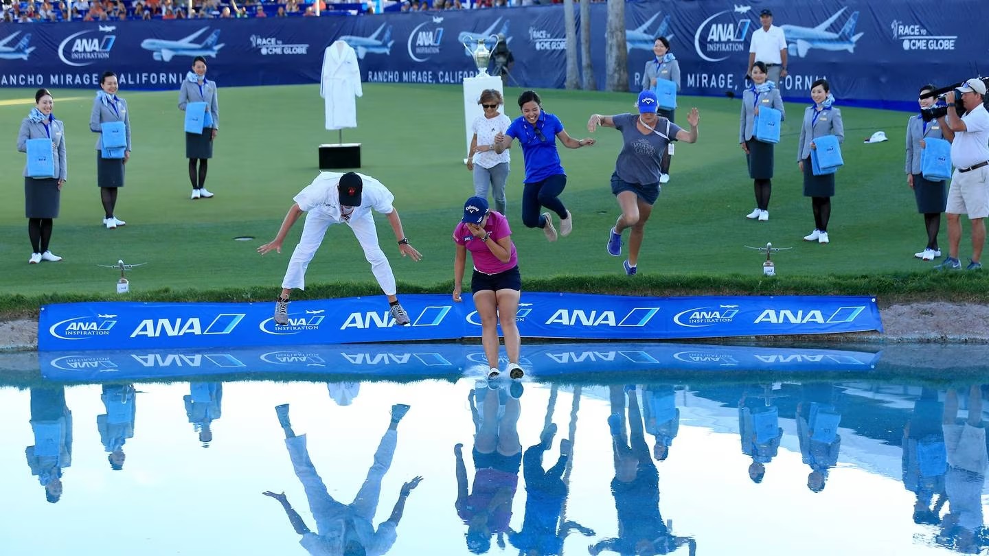 Lydia Ko and her team leap into Poppie's Pond at the 18th green after her victory in the final round of the 2016 ANA Inspiration at the Mission Hills Country Club. Photo / Getty