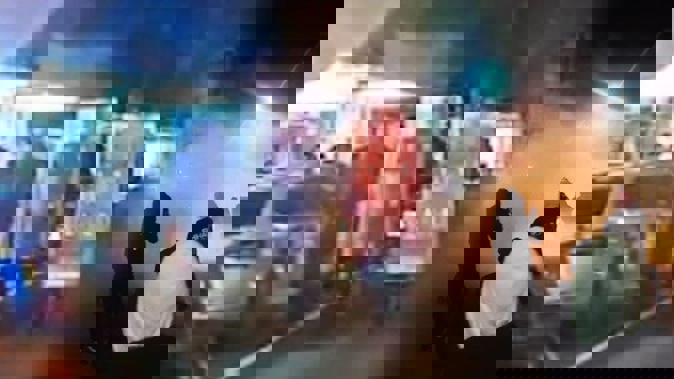 A composite image edited by the Herald of the boy racer event in Levin on May 30: Police responding in riot gear and crowds watching burnouts and skids.