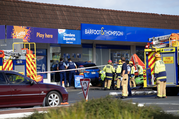 A car has smashed into a Barfoot & Thompson office in Auckland's Glendene. Photo / Hayden Woodward