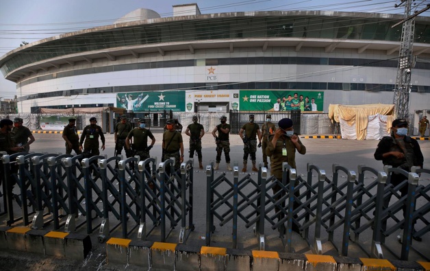 Pakistan paramilitary troops and police officer stand guard outside the Pindi Cricket Stadium following the cancellation of the tour. (Photo / AP)